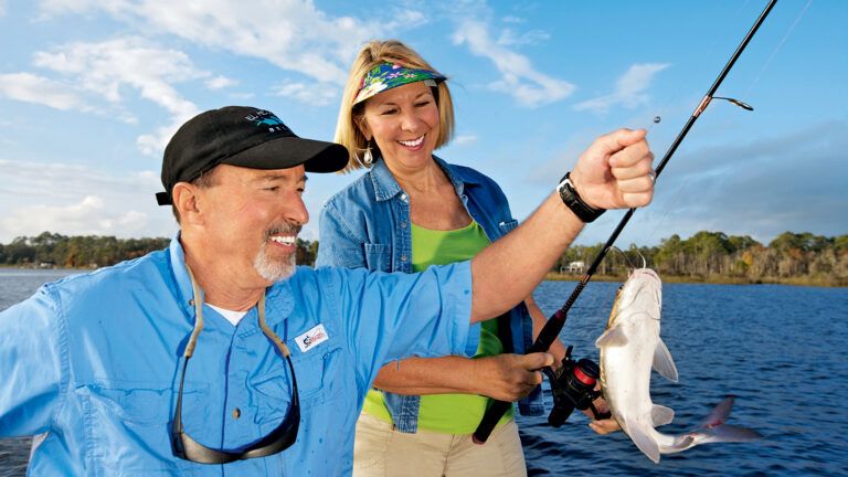 Marilyn Turk and her husband catch a fish