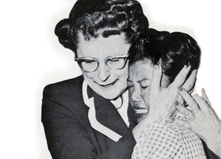 Edith Taylor and Aiko embrace at the airport