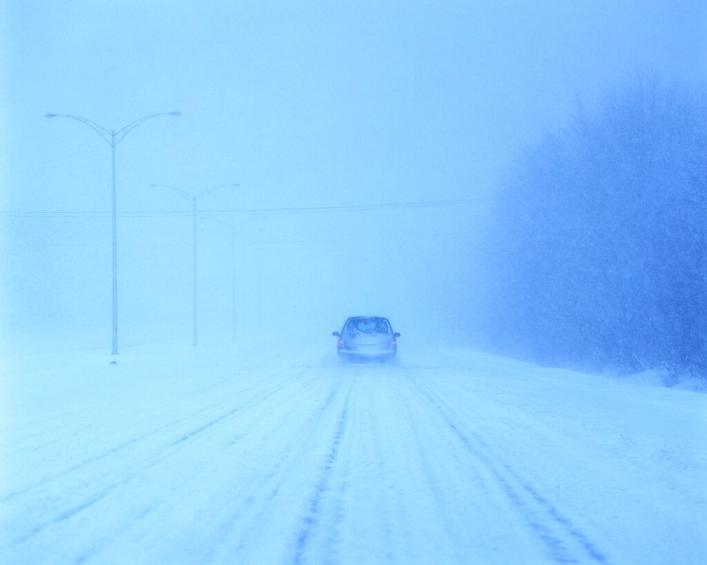 Car in blizzard conditions.