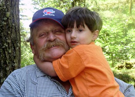 Marie Olson's late husband, Butch, with a grandchild