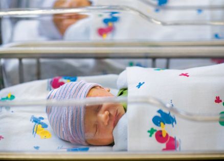 A sleeping infant in a hospital nursery