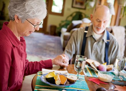 Susan Carlyle and her husband, Kim, say grace at the dinner table