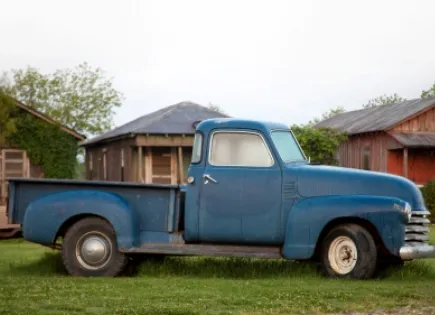 blue pick-up truck on a farm.