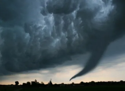 A frightening tornado descending on a town.