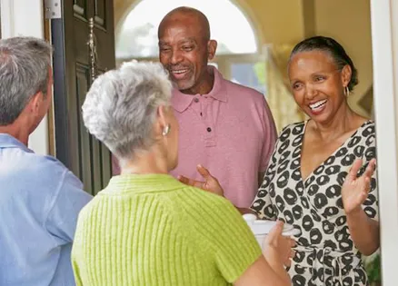 A couple brings a welcome gift of food to their neighbors.