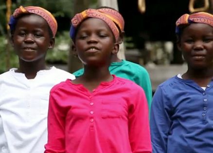 A children's choir dancing while singing "What a Wonderful World"