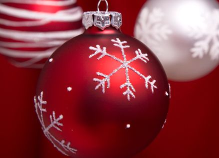 A red Christmas ornament with silver glitter