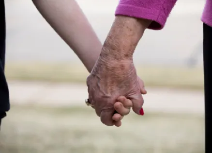 A grandmother and her grandson holding hands