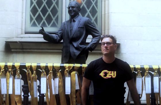 Mitch Horowitz poses with a statue of Norman Vincent Peale.