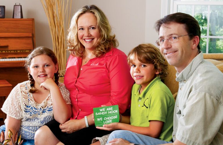 Katie, Julie, Eli and Tim pose with a We Choose Love sign