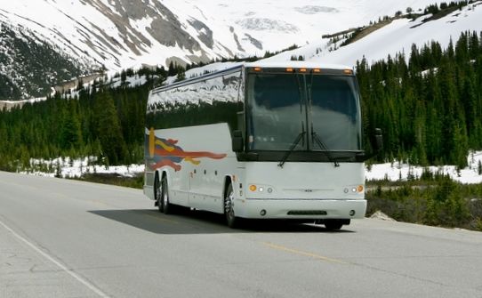 Bus going down the road in winter.