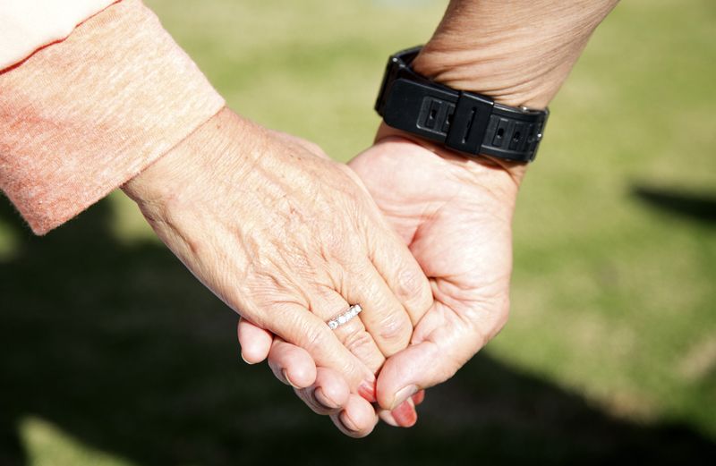 A senior couple holding hands