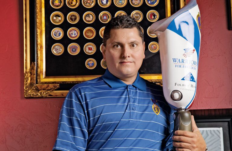 Major Edward Pulido poses with his prosthetic leg.