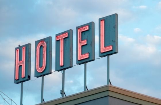 Hotel sign against a blue sky.