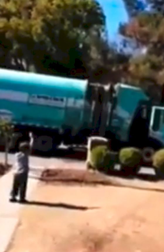 Boy waves to garbage truck