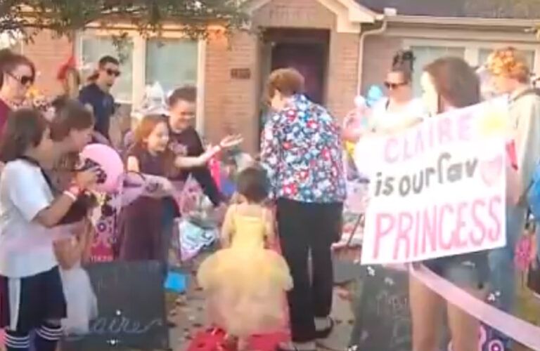 Little girl walks home through crowd of fans