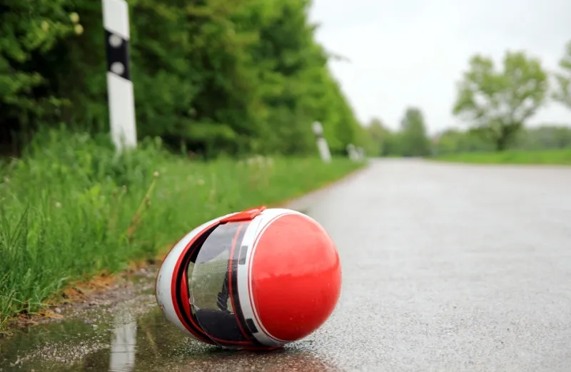 motorcycle helmet on the pavement, in the road