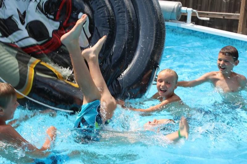 Boys playing in the pool.