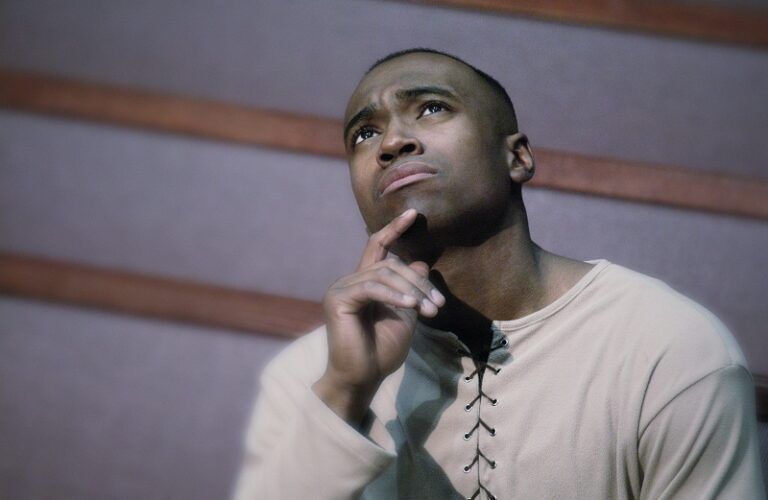 Photo of a man in a church pew listening intently