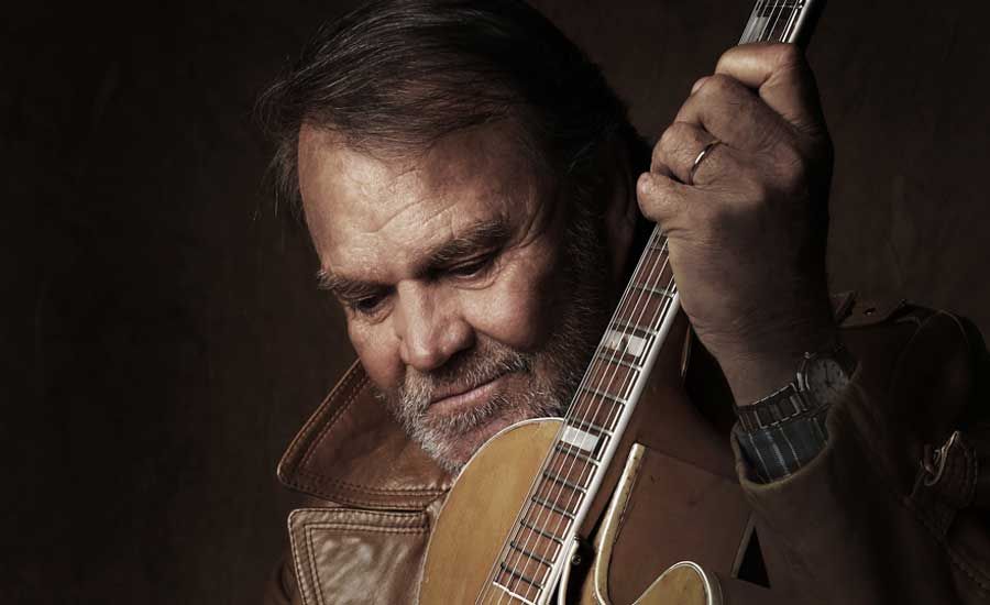 Glen Campbell holding a guitar