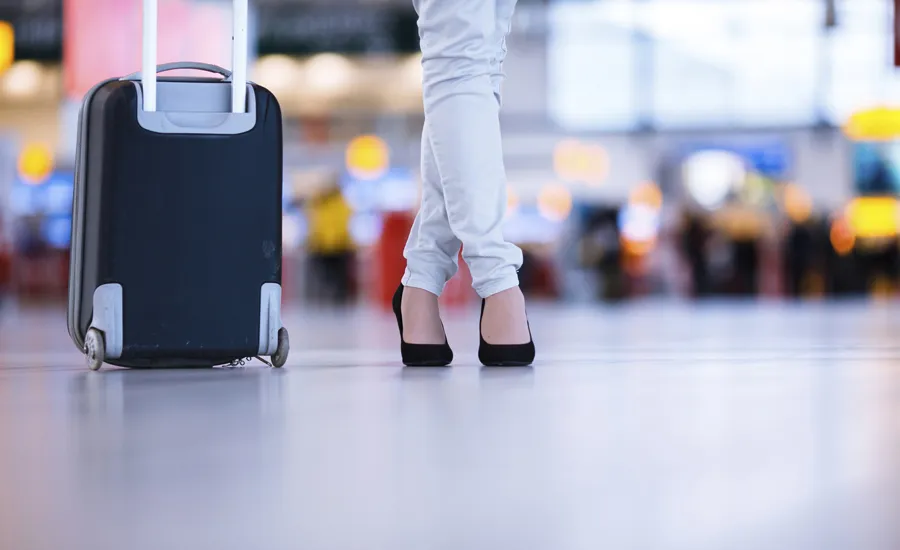 A woman waits in an airport, unaware her oldest friend is nearby.