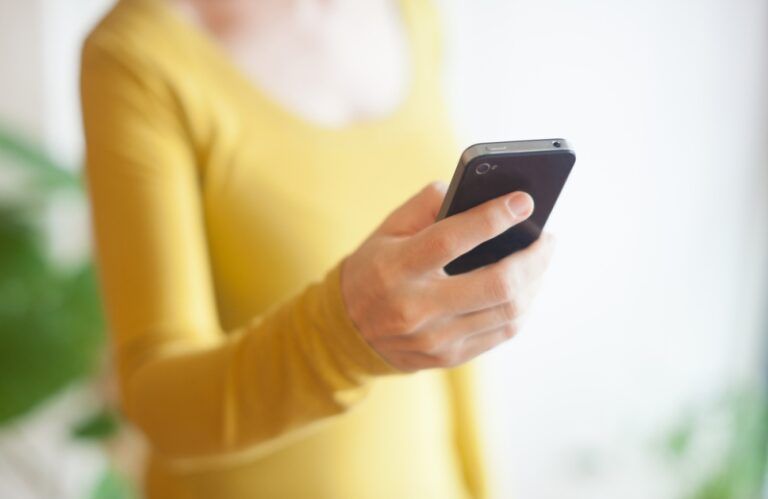 Woman making a cell phone call. Shutterstock.