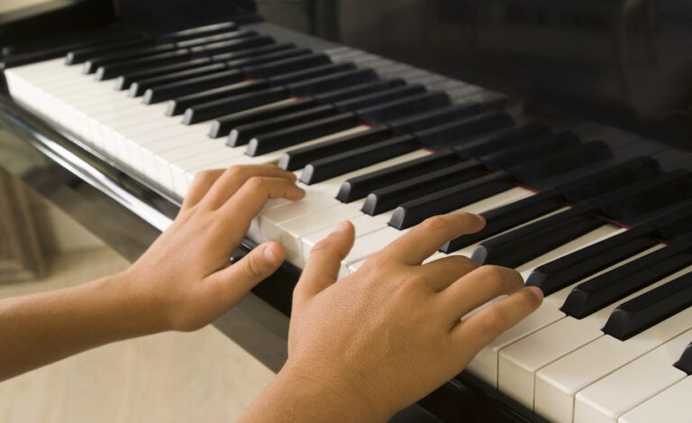 Boys hands playing piano. Thinkstock.