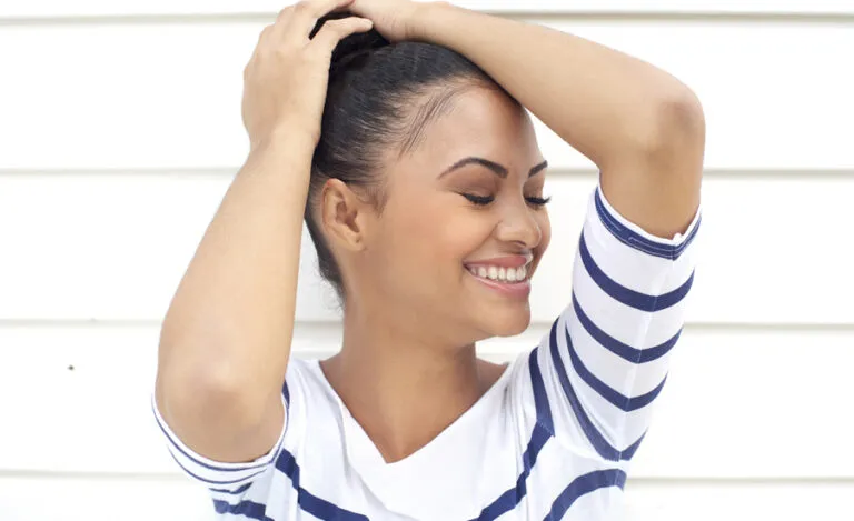 Woman embracing herself smiling