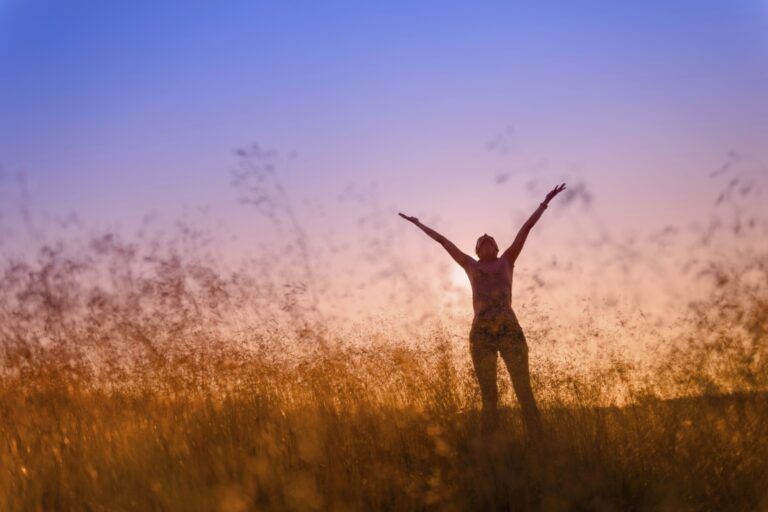 woman in a field at sunrise