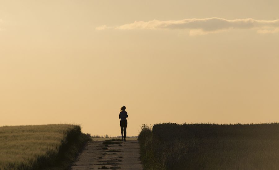 Woman running in a field. Photo: Thinkstock.