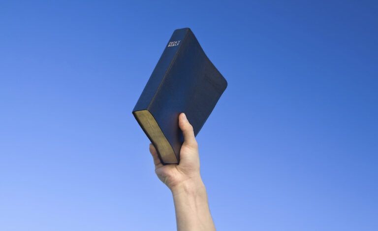 Holding the Bible as a source of protection and comfort.