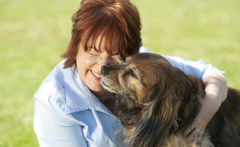 Peggy gets a kiss from her spaniel, Kelly.