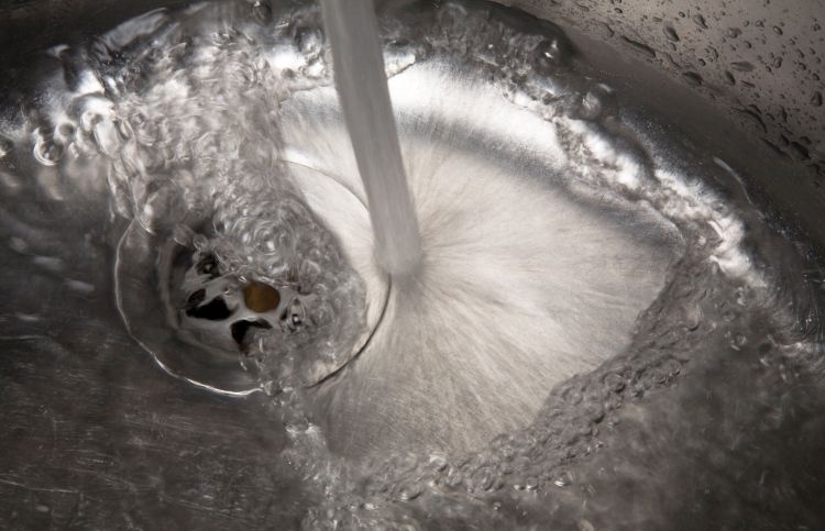 A woman is mysteriously led to fill an empty jug of water