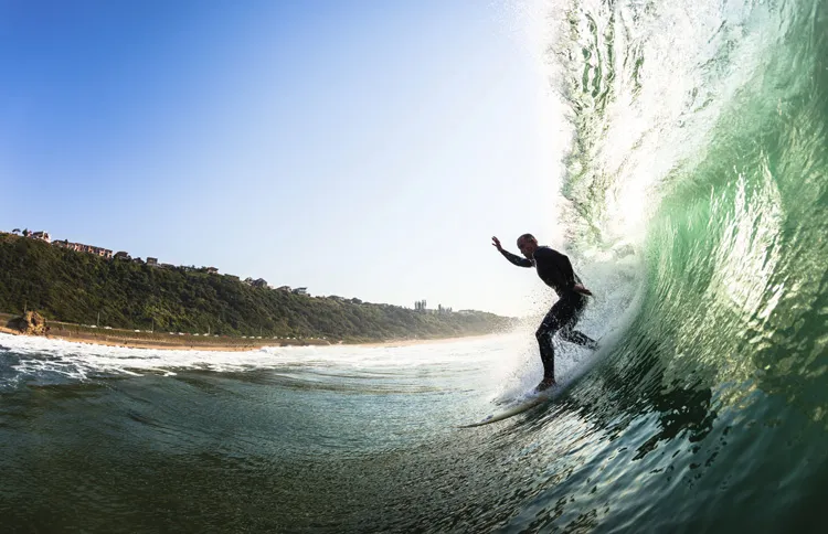 Surfer riding a wave with a new year bible verse