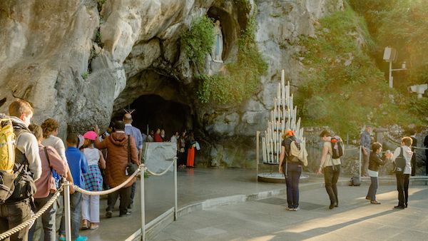 Statue of St. Bernadette at the grotto near Lourdes and the miracle story of the winds.