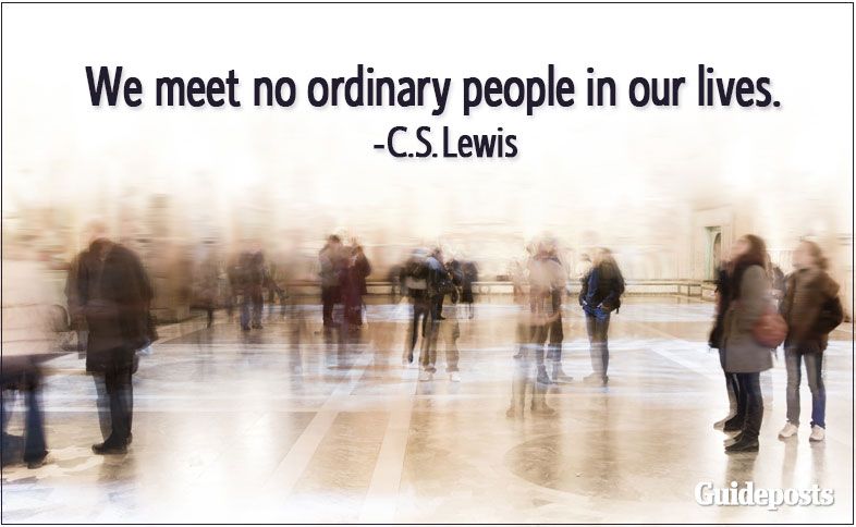 Blurred people walking in a room with C.S. Lewis quotes