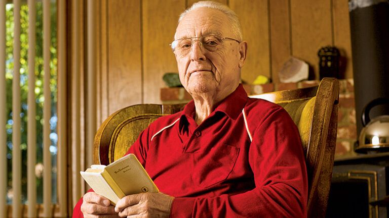 Al McDowell holds the small, white Bible he received in the military