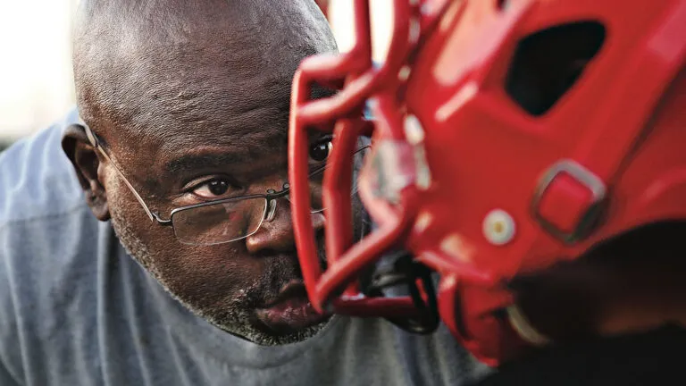 Coach Keith Johnson gives his undivided attention to his young players.