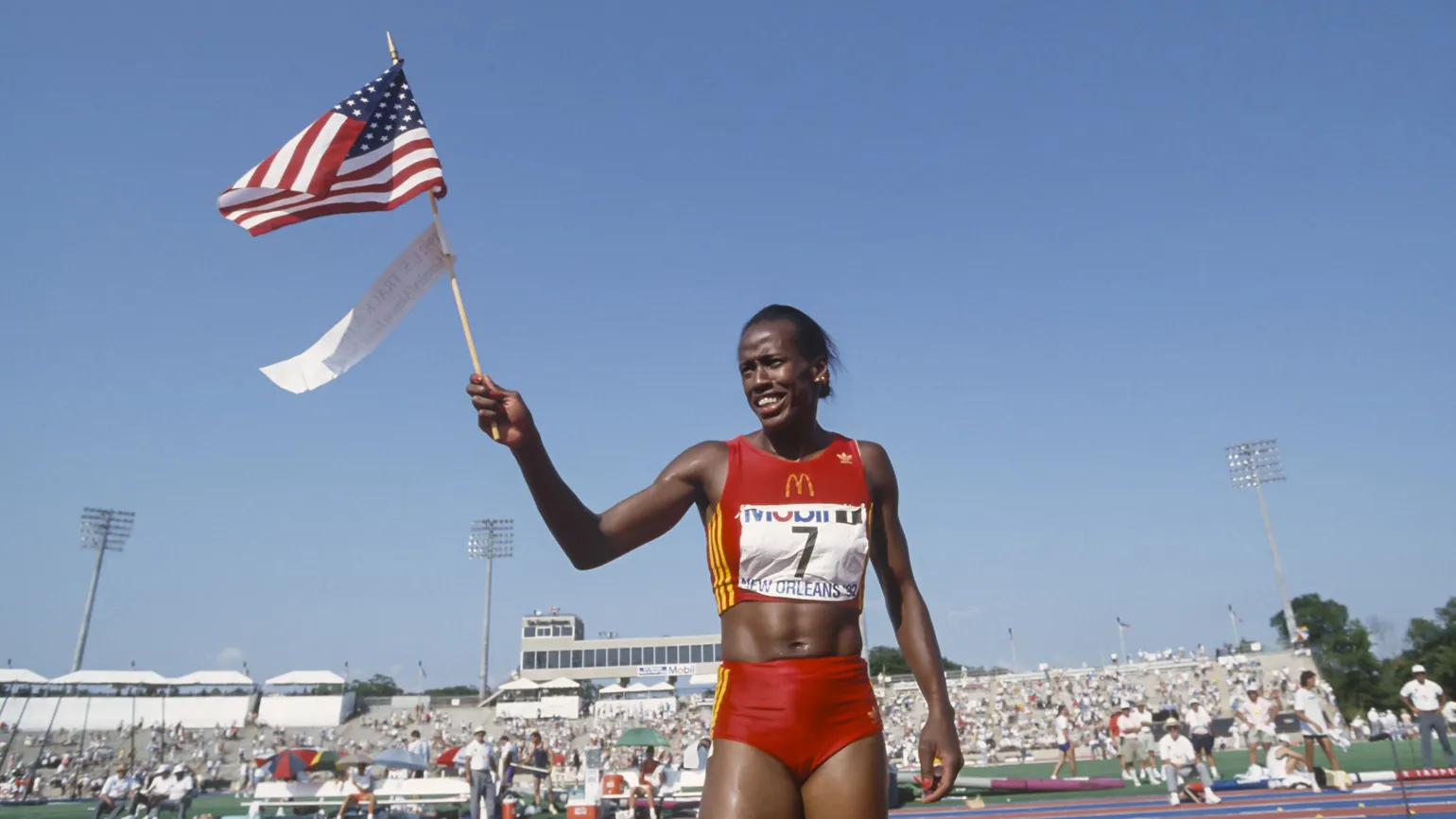 Jackie Joyner-Kersee walks with an American flag as an inspiring Black History Month figure