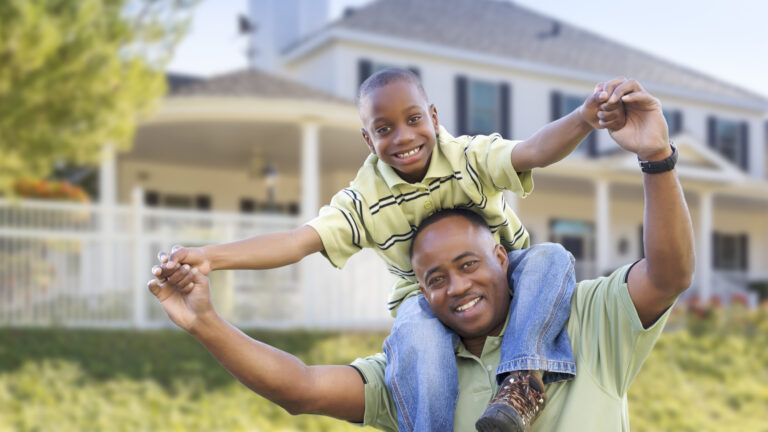 father playing with son at home on spring break