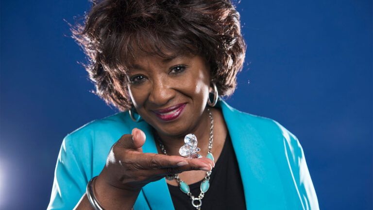 Jo Ann Obie holds in her hand the crystal butterfly she received as a gift