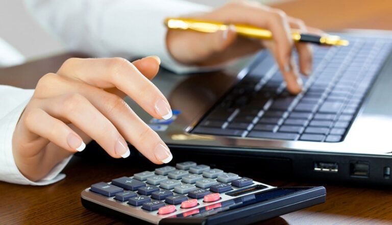 Woman calculating numbers using a calculator