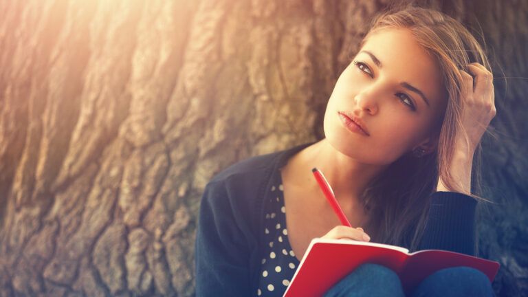 A young woman writes in her journal.