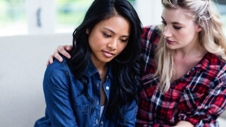 Friends comforting each other