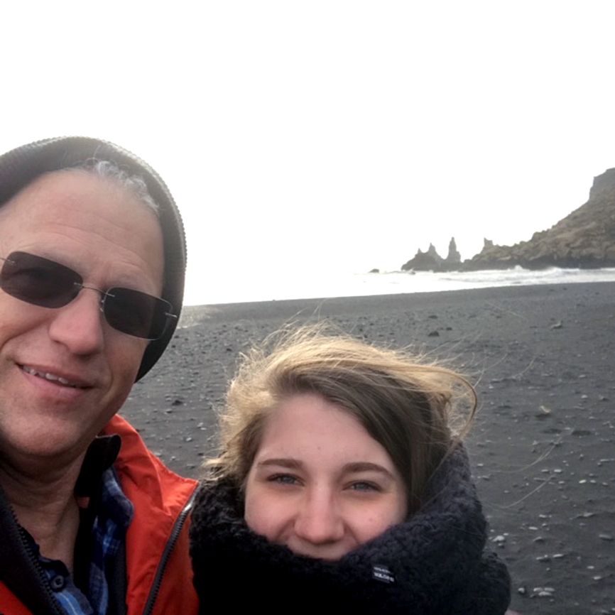 Alikay and her father on Reynisfjara, a black sand beach