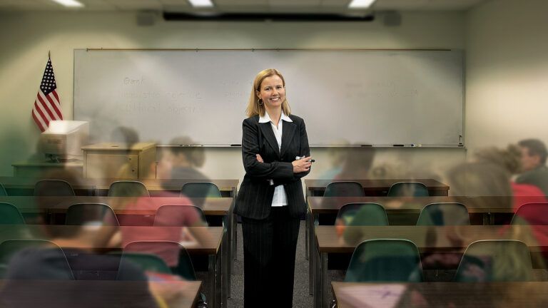 Joyce stands surrounded by her students in a classroom