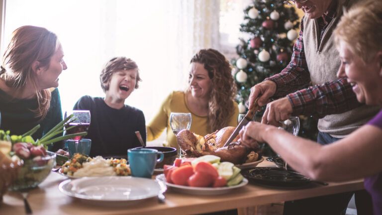 A happy family around the dinner table during the holiday season.