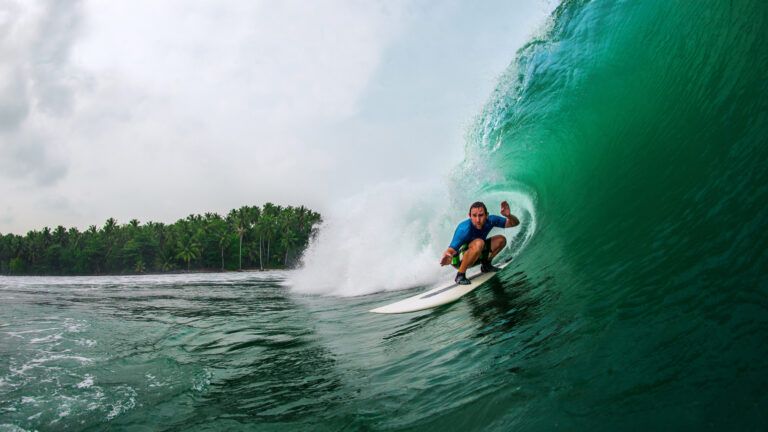 A surfer rides a big wave