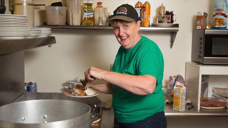 Diner operator Tammy Kronz says resident volunteers help her pass savings on to customers. "They may not be speed demons," says Tammy of her volunteers, "but because of the fact that they work for nothing — they work for tips only — it helps keep the prices down. “