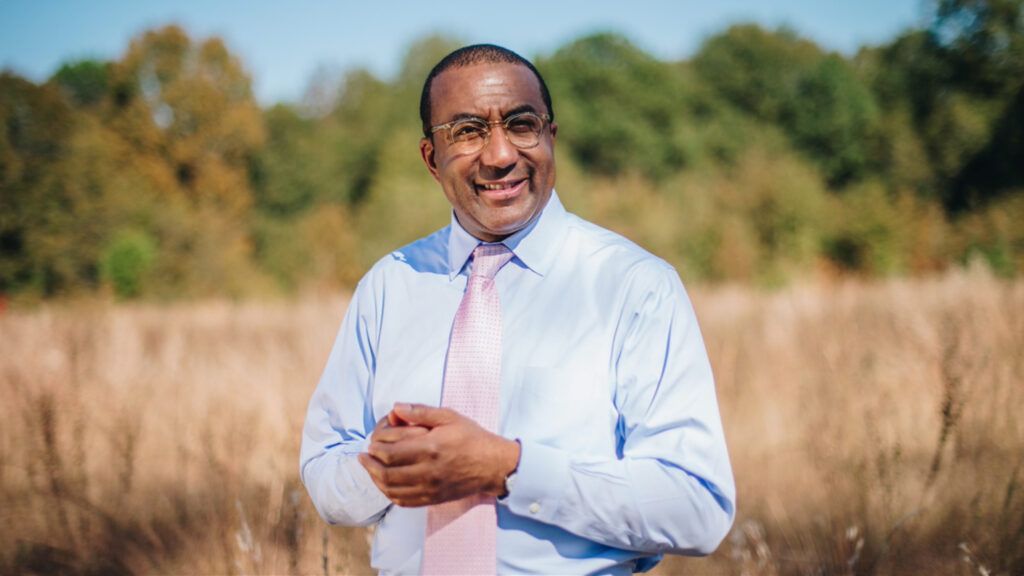 A portrait of Eric Motley on the wheat plains of Madison Park, Alabama.